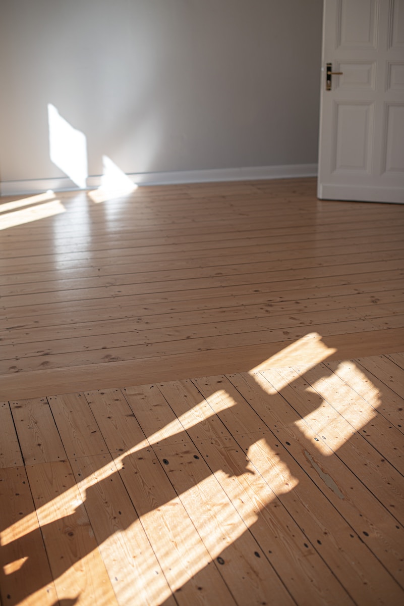 a wood floor with a white door