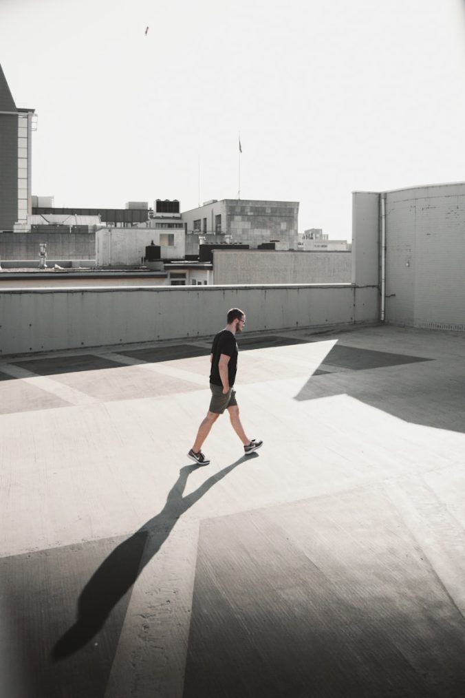 man walking on building roof top